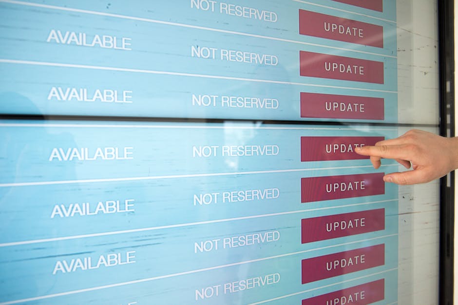 A close-up image of a computer screen displaying colored lines of programming code, set against a dark background. The code features various syntax highlighted in multiple colors, including pink, blue